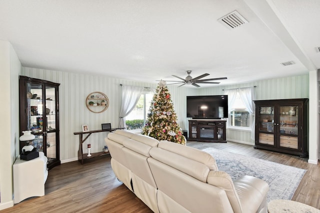 living room featuring hardwood / wood-style floors and ceiling fan