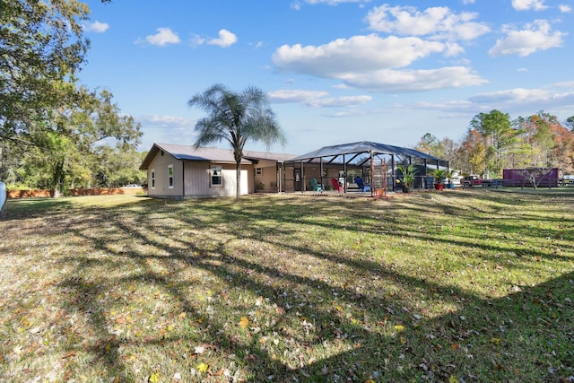 view of yard with glass enclosure