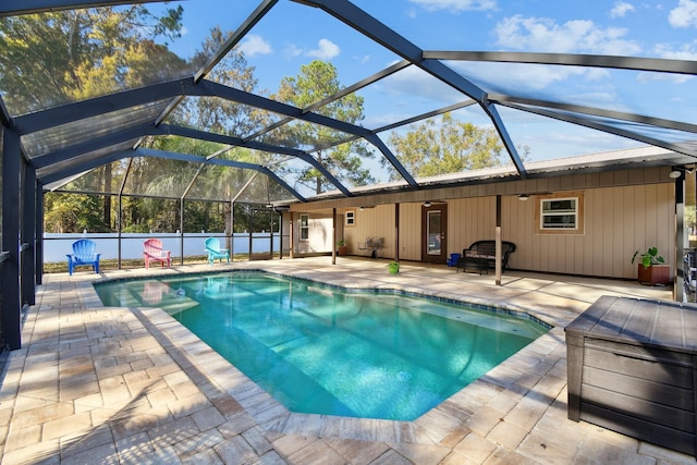 view of pool with a patio and a lanai