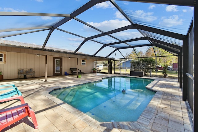 view of pool with a patio area and a lanai