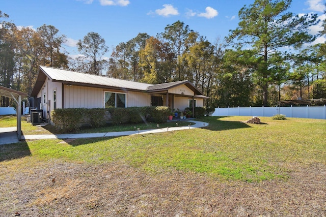 single story home featuring a front lawn and cooling unit