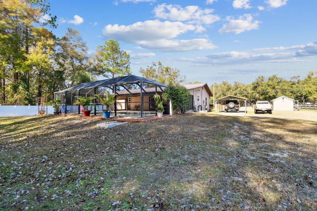 view of front of house featuring glass enclosure and a carport