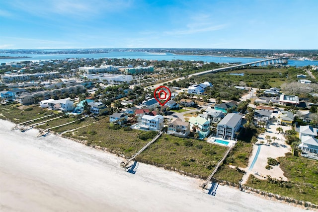 drone / aerial view featuring a beach view and a water view