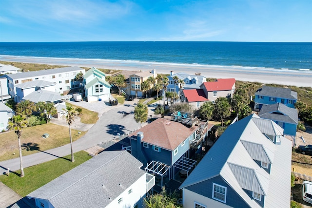 drone / aerial view with a beach view, a residential view, and a water view