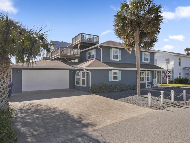 view of front facade featuring a garage and a deck