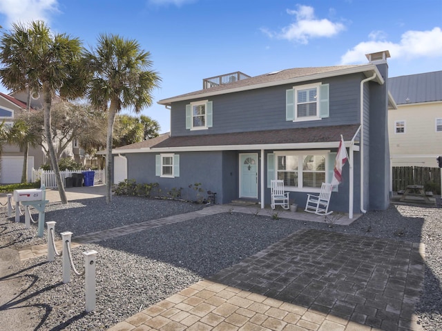 view of front of home featuring fence