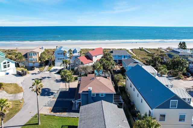 birds eye view of property with a view of the beach and a water view