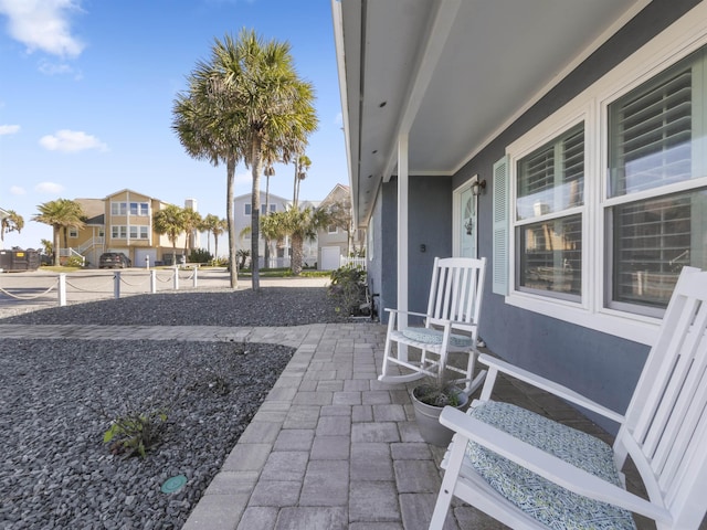 view of patio with covered porch and a residential view