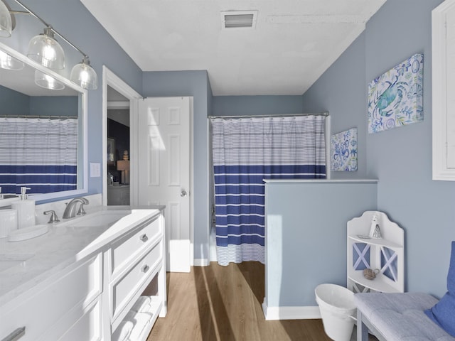 bathroom with hardwood / wood-style floors, vanity, and a shower with curtain