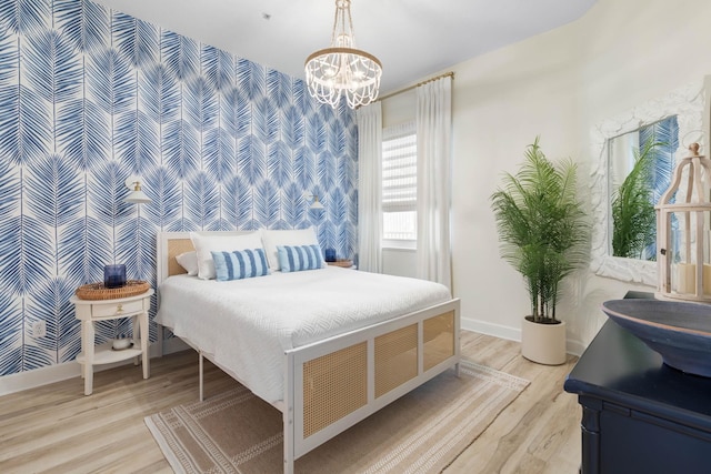 bedroom featuring light wood-type flooring and an inviting chandelier