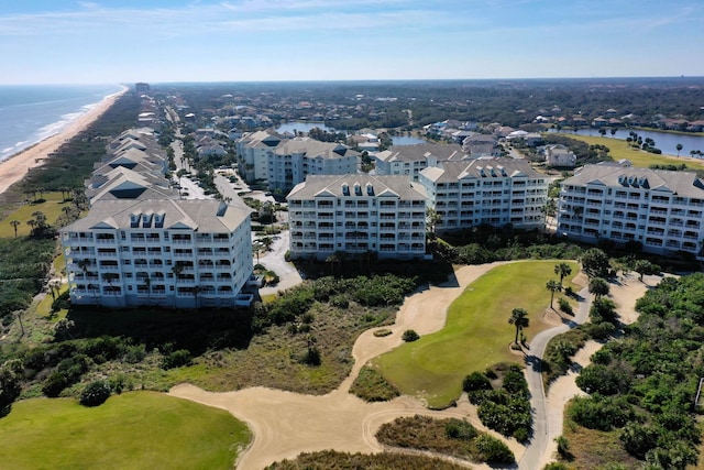 birds eye view of property featuring a water view and a view of the beach