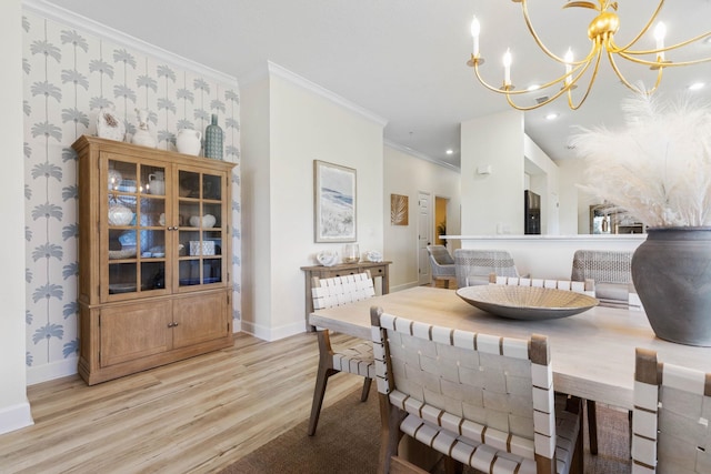 dining area with a notable chandelier, light hardwood / wood-style flooring, and crown molding