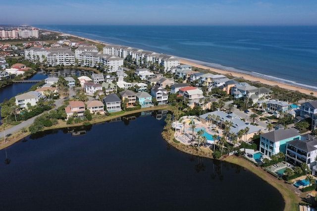 bird's eye view with a water view and a beach view