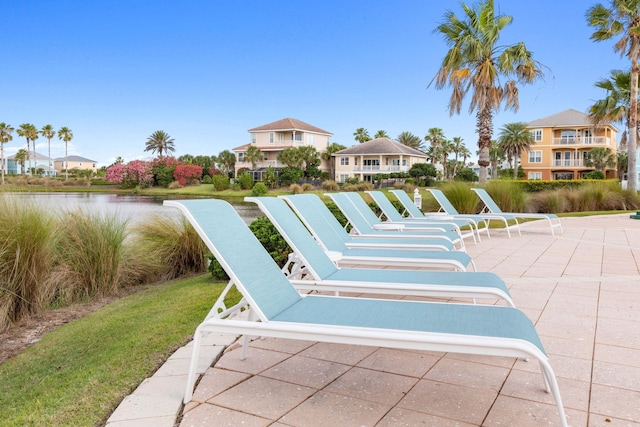 view of property's community featuring a water view and a patio