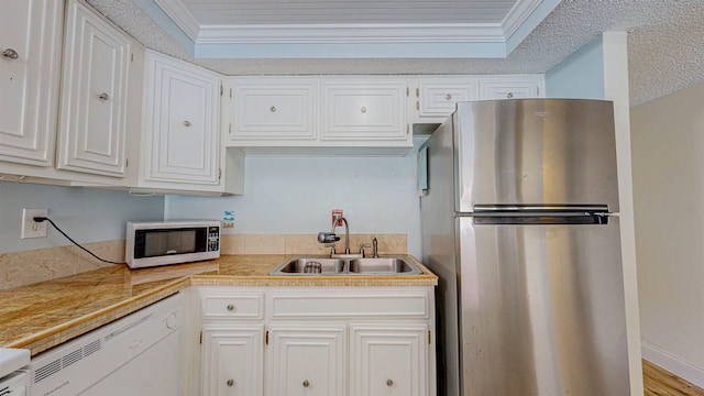 7175 A1A S # F238 # F238, Saint Augustine, FL 32080 - kitchen featuring white appliances, a sink, white cabinetry, ornamental molding, and tile counters