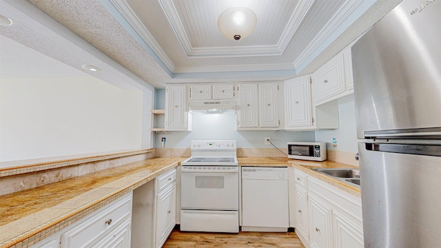 7175 A1A S # F238 # F238, Saint Augustine, FL 32080 - kitchen with white appliances, under cabinet range hood, a tray ceiling, ornamental molding, and white cabinets