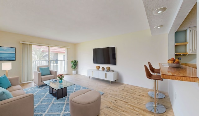 7175 A1A S # F238 # F238, Saint Augustine, FL 32080 - living area featuring light wood-type flooring, recessed lighting, a textured ceiling, and baseboards