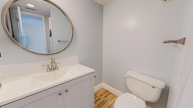 7175 A1A S # F238 # F238, Saint Augustine, FL 32080 - bathroom featuring toilet, wood finished floors, vanity, and baseboards