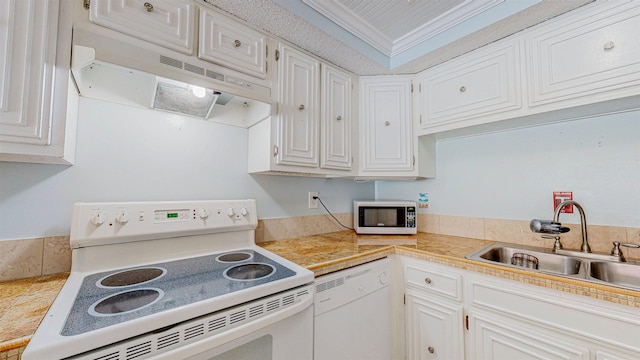 7175 A1A S # F238 # F238, Saint Augustine, FL 32080 - kitchen featuring white appliances, under cabinet range hood, a sink, white cabinets, and crown molding