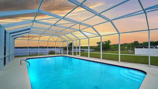 view of swimming pool with a fenced in pool, a patio, a lawn, glass enclosure, and fence