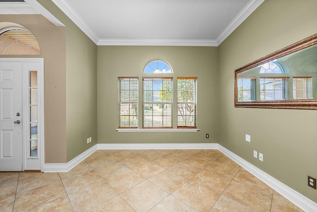 tiled foyer entrance with crown molding and a healthy amount of sunlight