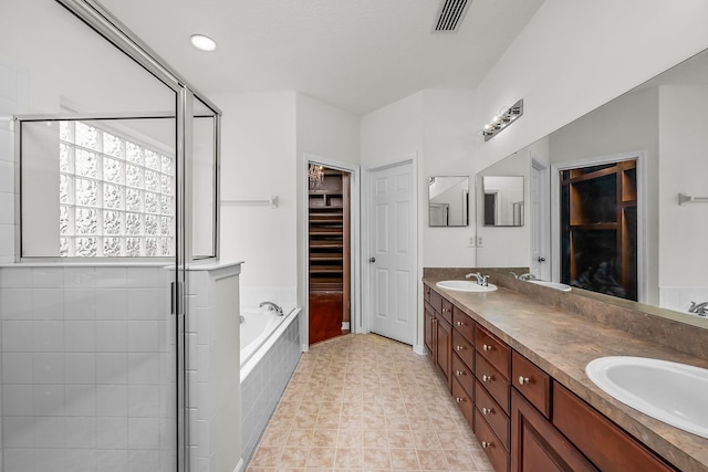 bathroom featuring shower with separate bathtub and vanity