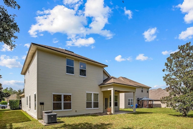 back of house featuring a lawn, central AC unit, and a patio