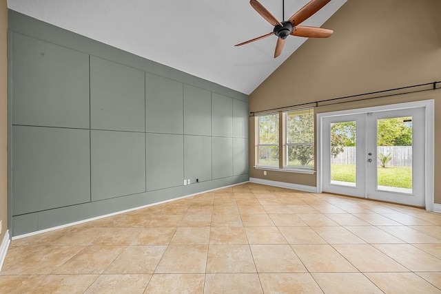 empty room featuring light tile patterned floors, french doors, high vaulted ceiling, and ceiling fan