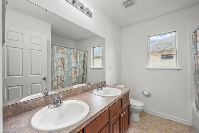 full bathroom featuring vanity, toilet, and shower / tub combo