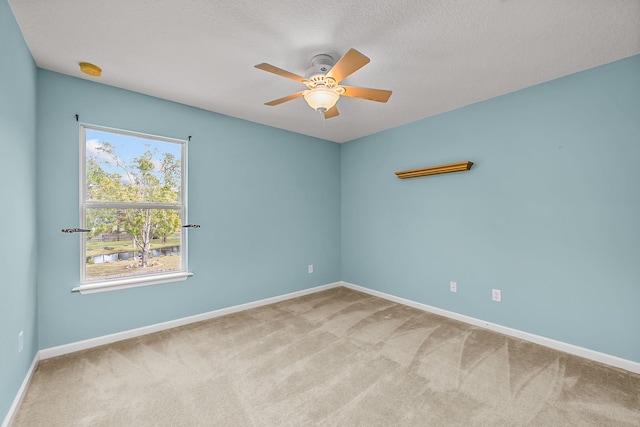 carpeted empty room featuring a textured ceiling and ceiling fan