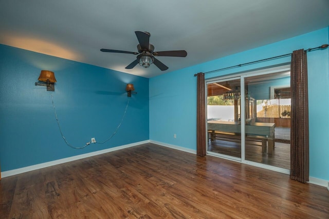 unfurnished room featuring ceiling fan and dark hardwood / wood-style flooring