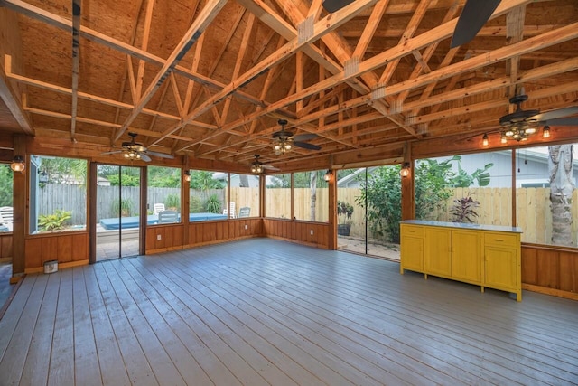 unfurnished sunroom featuring plenty of natural light and lofted ceiling