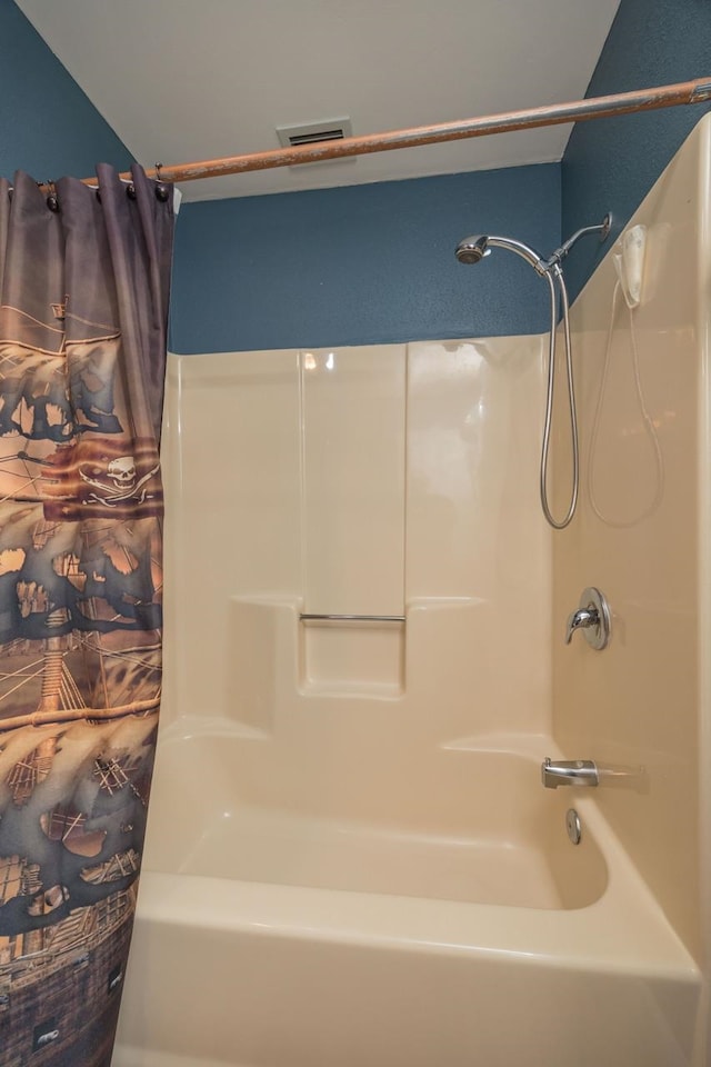 bathroom with shower / bath combination with curtain