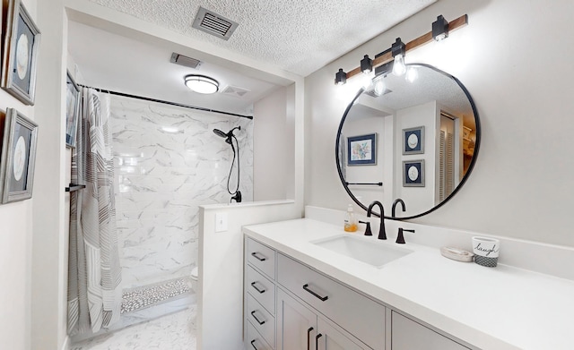 bathroom featuring vanity, a textured ceiling, and a shower with shower curtain