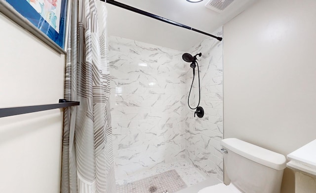 bathroom with a shower with curtain and toilet