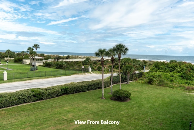 exterior space with a water view and a lawn