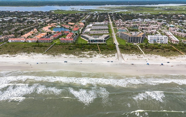 birds eye view of property with a water view and a view of the beach