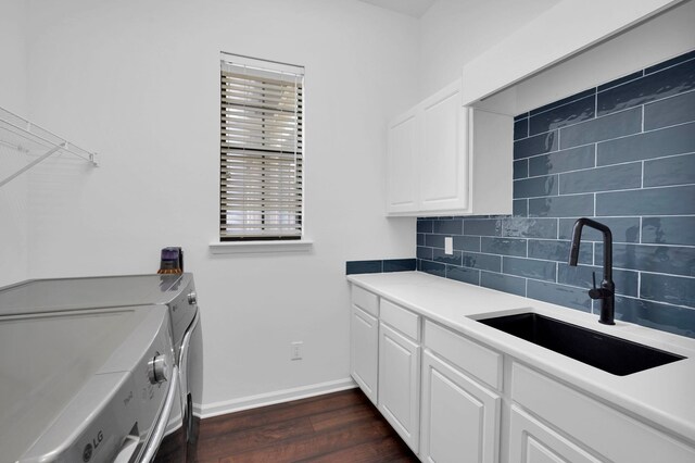 545 Sebastian Sq, Saint Augustine, FL 32095 - laundry room with washer and clothes dryer, cabinet space, dark wood-type flooring, and baseboards