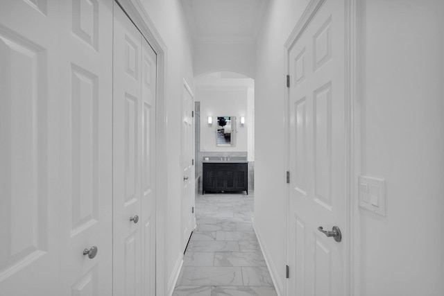 545 Sebastian Sq, Saint Augustine, FL 32095 - hallway with arched walkways, light marble finish flooring, baseboards, and ornamental molding