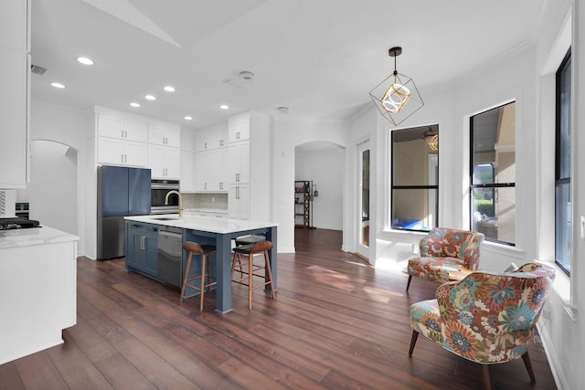 545 Sebastian Sq, Saint Augustine, FL 32095 - kitchen with arched walkways, appliances with stainless steel finishes, tasteful backsplash, white cabinetry, and recessed lighting