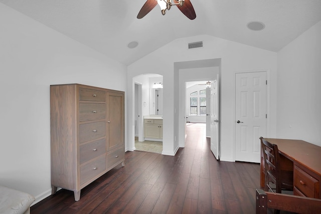 545 Sebastian Sq, Saint Augustine, FL 32095 - bedroom featuring vaulted ceiling, dark wood finished floors, arched walkways, connected bathroom, and baseboards