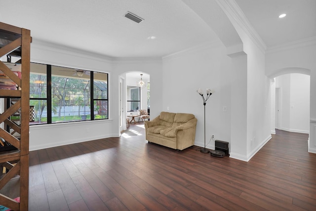545 Sebastian Sq, Saint Augustine, FL 32095 - living area featuring arched walkways, baseboards, ornamental molding, dark wood-style flooring, and recessed lighting