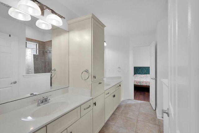 545 Sebastian Sq, Saint Augustine, FL 32095 - bathroom featuring vanity, tile patterned flooring, ensuite bathroom, a tile shower, and baseboards