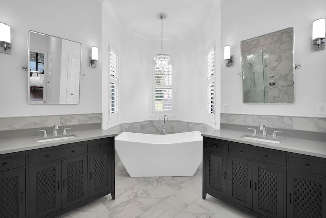 545 Sebastian Sq, Saint Augustine, FL 32095 - bathroom with a chandelier, ornamental molding, a marble finish shower, a freestanding tub, and two vanities