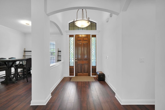 545 Sebastian Sq, Saint Augustine, FL 32095 - foyer entrance with arched walkways, dark wood-type flooring, and baseboards