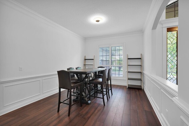 545 Sebastian Sq, Saint Augustine, FL 32095 - dining space with dark wood-style floors, a decorative wall, ornamental molding, and wainscoting