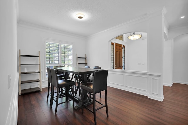 545 Sebastian Sq, Saint Augustine, FL 32095 - dining room featuring arched walkways, ornamental molding, dark wood finished floors, and a textured ceiling