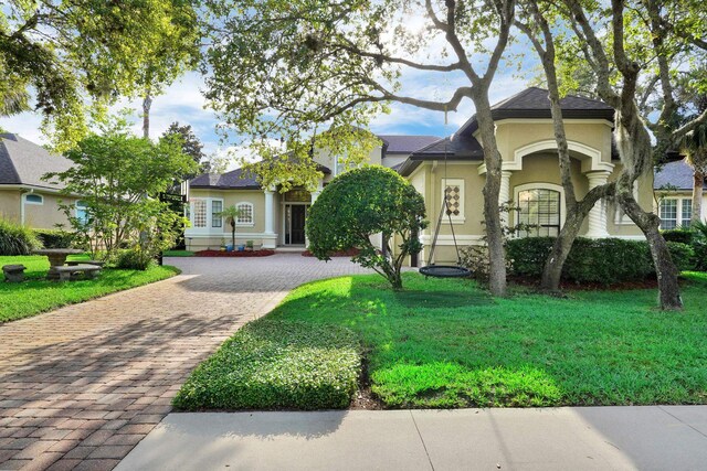 545 Sebastian Sq, Saint Augustine, FL 32095 - view of front facade with decorative driveway, stucco siding, and a front yard