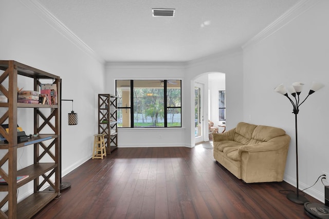 545 Sebastian Sq, Saint Augustine, FL 32095 - sitting room with arched walkways, baseboards, dark wood-type flooring, and crown molding