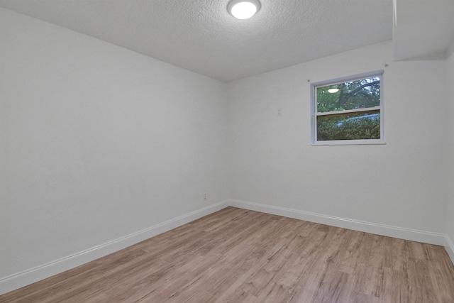 235 N Whitney St, Saint Augustine, FL 32084 - spare room featuring light wood-style flooring and a textured ceiling